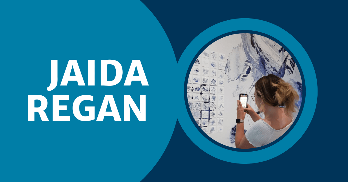 Text with Jaida Regan in bold white letters with medium blue background with a circle image of Jaida taking a picture of neat AI art at the Vancouver Art Gallery